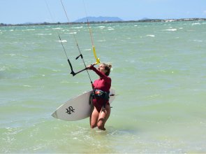 person-surfing-and-flying-a-parachute-at-the-same-time-in-kitesurfing-bonaire-caribbean-2